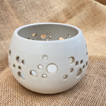 Load image into Gallery viewer, Ceramic holder with holes on a textured beige fabric background
